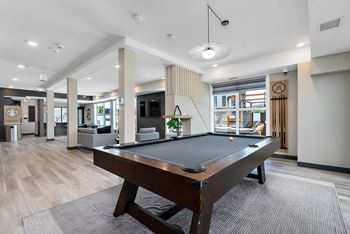 A pool table in a room with a striped wallpaper.
